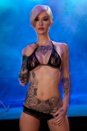 Hot tattooed Kleio Valentien sheds black lace panties to squat & spread legs on adultfans.net