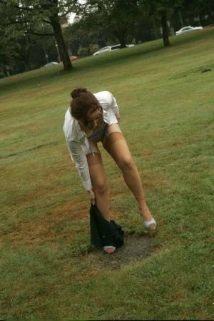 Amateur chick Dirty Angie strips to her pretties and tan nylons in a park on adultfans.net
