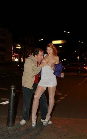 Slutty LaMia in white stockings topless sucks on her knees in the street on adultfans.net