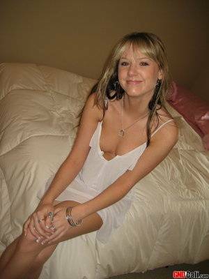 Cute teen Cali strips out of her little white nighty on adultfans.net