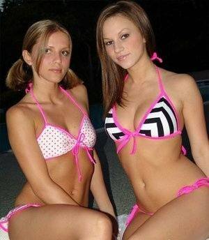 Young lesbians take off their bikinis in a safe for work manner at night on adultfans.net