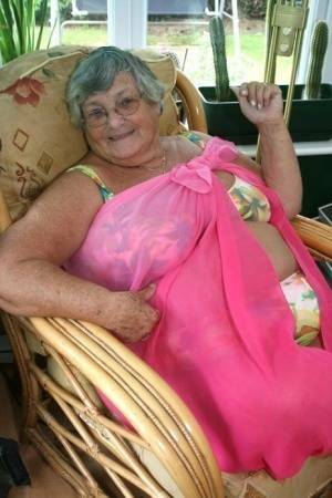 Horny old granny in glasses disrobes to reveal huge saggy tits & big BBW ass on adultfans.net