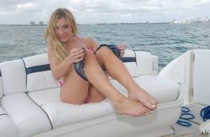 Lusty blonde Amy Brooke strips bikini and rubs pussy on the boat on adultfans.net