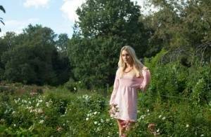 Dirty blonde Dolly touches her hairy teen pussy with a white rose on a lawn on adultfans.net