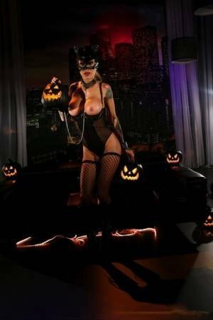 Tattooed chick Sarah Jessie exposes her tits and twat in a Catwoman mask on adultfans.net