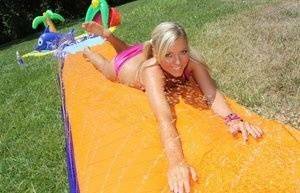 Young blonde Ally Kay ends a water fight by having sex in backyard on adultfans.net