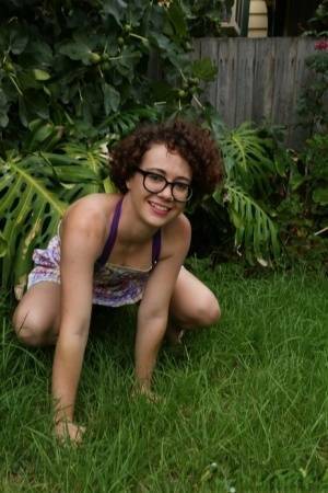 Geeky girl Rosie wears her glasses for her nude debut on the back lawn on adultfans.net