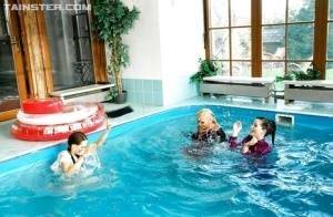 Playful fetish ladies have some fully clothed fun in the pool on adultfans.net