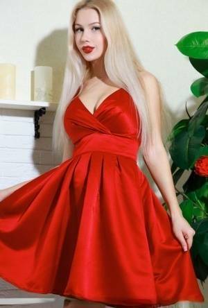 Nice blonde teen Genevieve Gandi removes red dress to display her trimmed muff on adultfans.net