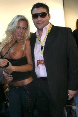 Blonde MILF Silvia Saint fully clothed posing & flaunting big tits at party on adultfans.net
