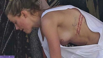 Amber Heard caught topless on the beach on adultfans.net