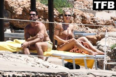 Michelle Hunziker & Giovanni Angiolini Relax on the Beach of Their Hotel in Sardinia on adultfans.net