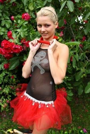 Cute blonde teen Buffy hikes up a tutu before masturbating in the back yard on adultfans.net