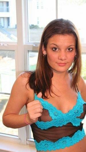 Young amateur Kate Crush places her hand over her exposed breasts on adultfans.net