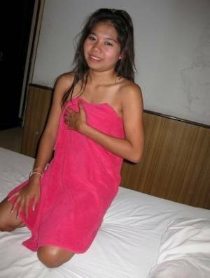 Petite Thai girl washes up her shaved pussy after bareback sex with a tourist - Thailand on adultfans.net