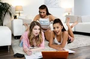 Young girls get busy with a lesbian threesome on a sofa ensemble on adultfans.net