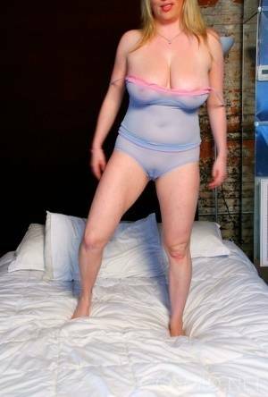 Blond amateur Maggie Green sports a cameltoe while unleashing her big naturals on adultfans.net