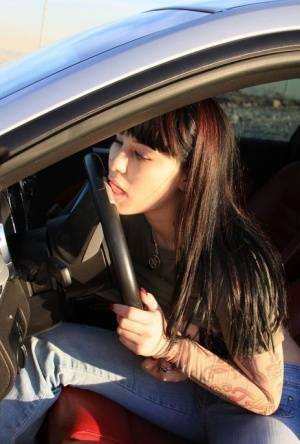 Amateur girl Susy Rocks flips the bird while exposing her big tits in a car on adultfans.net