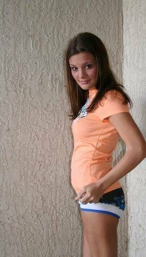 Cute teen Kate Crush strategically covers her enhanced breasts on adultfans.net