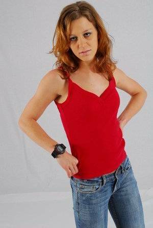 Natural redhead Sabine shows off her black G-shock watch while fully clothed on adultfans.net