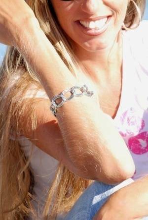 Amateur model Lori Anderson shows off her hairy arms while fully clothed on adultfans.net