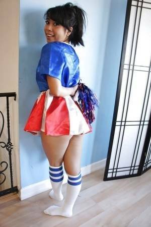 Tiny Asian cheerleader May Lee posing in cute uniform and socks on adultfans.net
