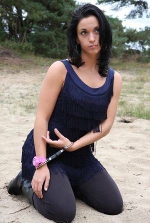 Brunette girl Nora is handcuffed to a tree while wearing a pink G-Shock watch on adultfans.net