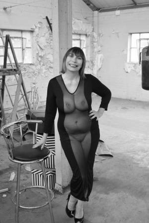 Middle-aged woman Barby Slut models a see-thru dress for a black-and-white gig on adultfans.net