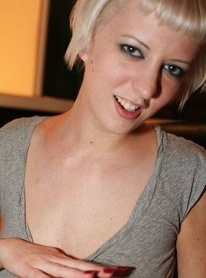 Short-haired blonde Cherry Torn revealing her big tits and shaved slit on adultfans.net