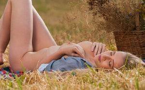 Blonde teen Penelope G displays her great body in a freshly cut farmer's field on adultfans.net