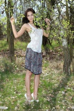 Long legged Michaela Isizzu flashes naked upskirt and poses nude in the forest on adultfans.net