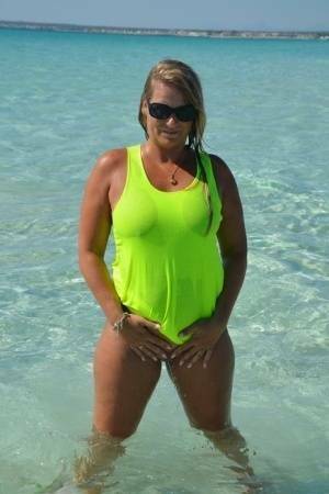 Middle-aged blonde Sweet Susi exposes her ass and pussy while in the ocean on adultfans.net