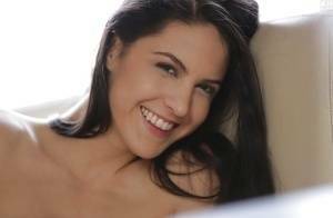 Latina pornstar Carolina Abril strips off her white bra and panties on adultfans.net