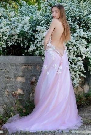 Beautiful girl Elle Tan slips off wedding dress to pose nude in garden on adultfans.net