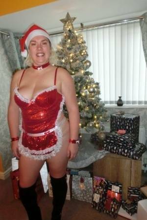 Busty blonde Barby masturbates her shaved pussy near the Christmas tree on adultfans.net