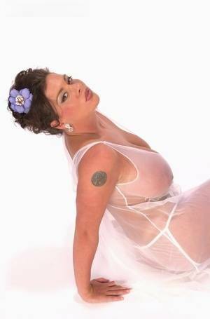 Buxom Linsey Dawn poses to flaunt her droopy tatas in sheer lingerie on adultfans.net