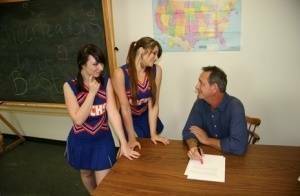 2 cheerleaders jerk off their geography teacher on top of his desk on adultfans.net