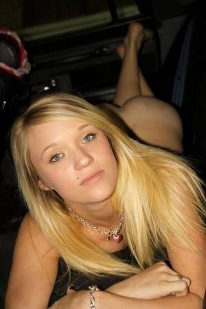 Blonde amateur Teagan slides lace panties aside to get naked inside a vehicle on adultfans.net