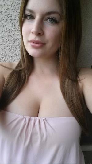 Plump amateur Danielle takes topless and clothed selfies around the house on adultfans.net