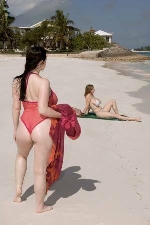 Plump female Christy Mark and her big boobed friend have lesbian sex on beach on adultfans.net