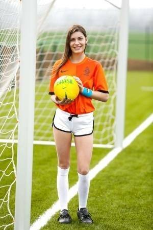 Lilly P is undressing her soccer uniform while on the field with a ball on adultfans.net