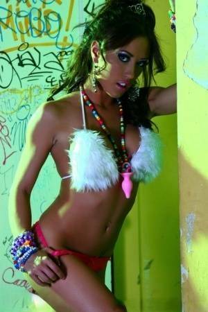 Hot MILF Capri Cavanni peels off her bikini amid graffiti in furry boots on adultfans.net