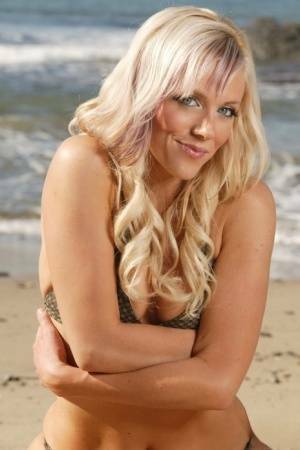 Blonde beauty Amy models on a sandy beach in her bikini on adultfans.net