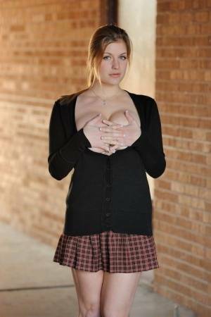Amateur abbe letting big natural schoolgirl tits loose outdoors in socks on adultfans.net
