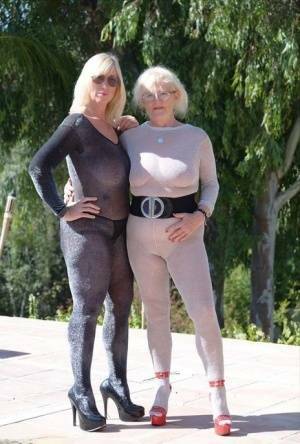 Mature blonde Melody and her lesbian lover bare their boobs on a building site on adultfans.net