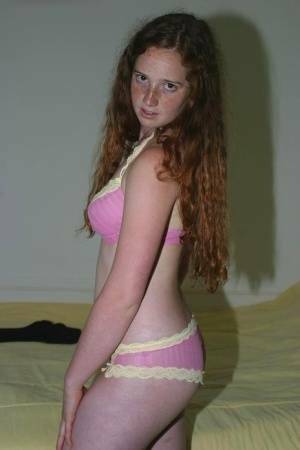 Flexible redhead Rachel showcases her natural pussy after lingerie removal on adultfans.net
