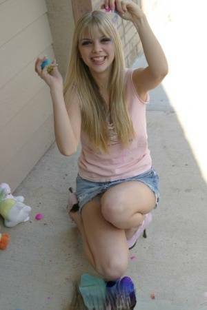 Sweet blonde teen Jana Jordan flashes upskirt panties while eating chocolate - Jordan on adultfans.net
