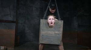 Blonde girl Odette Delacroix is made to suck a black cock with head in stocks on adultfans.net