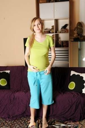 Smiley pregnant amateur with puffy nipples and hairy gash getting naked on adultfans.net