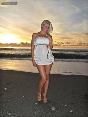 Hot blonde Anikka Albrite strips naked at the beach before nude hitchhiking on adultfans.net